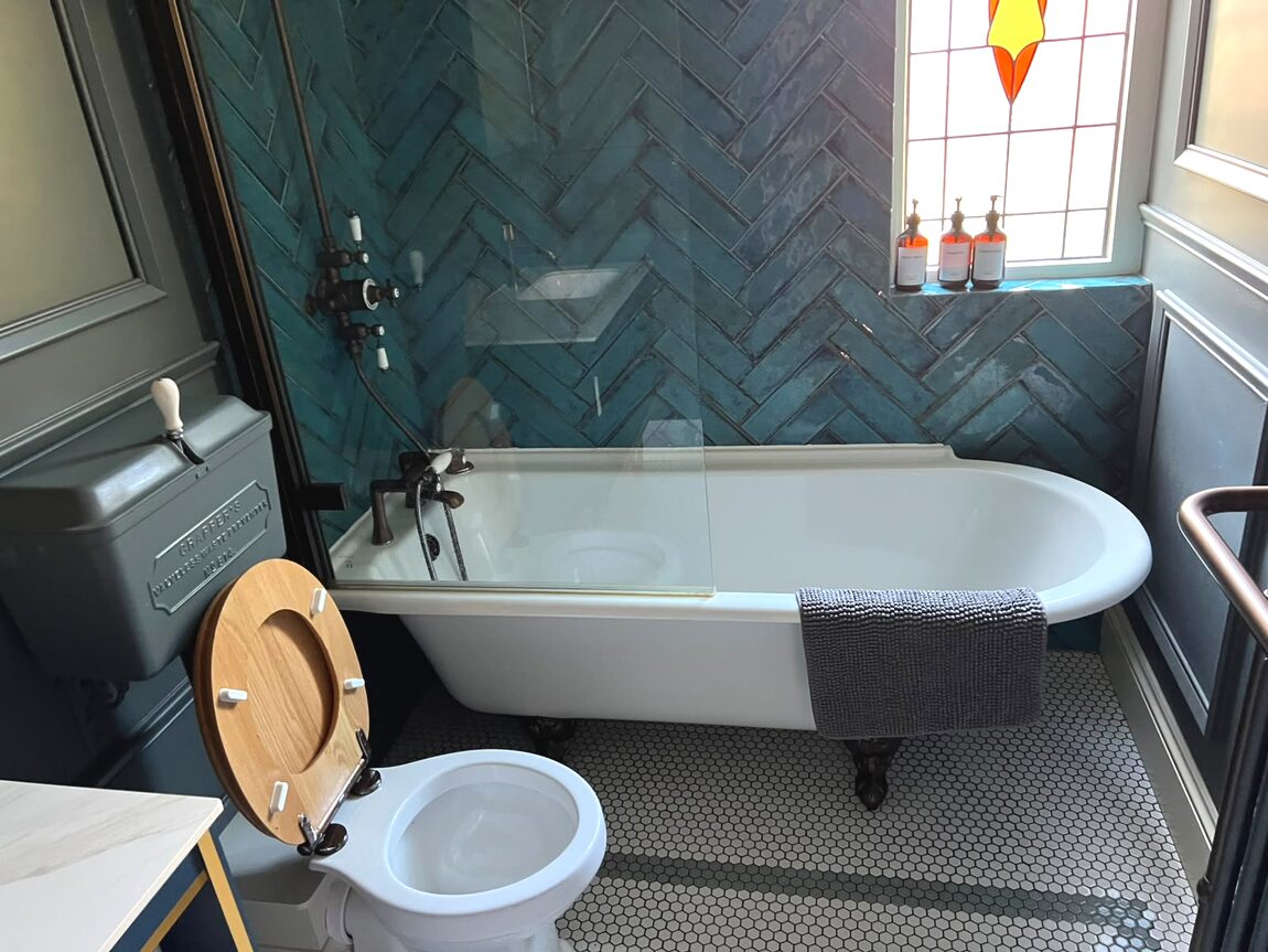 Tiled bathroom with roll top bath after cleaning